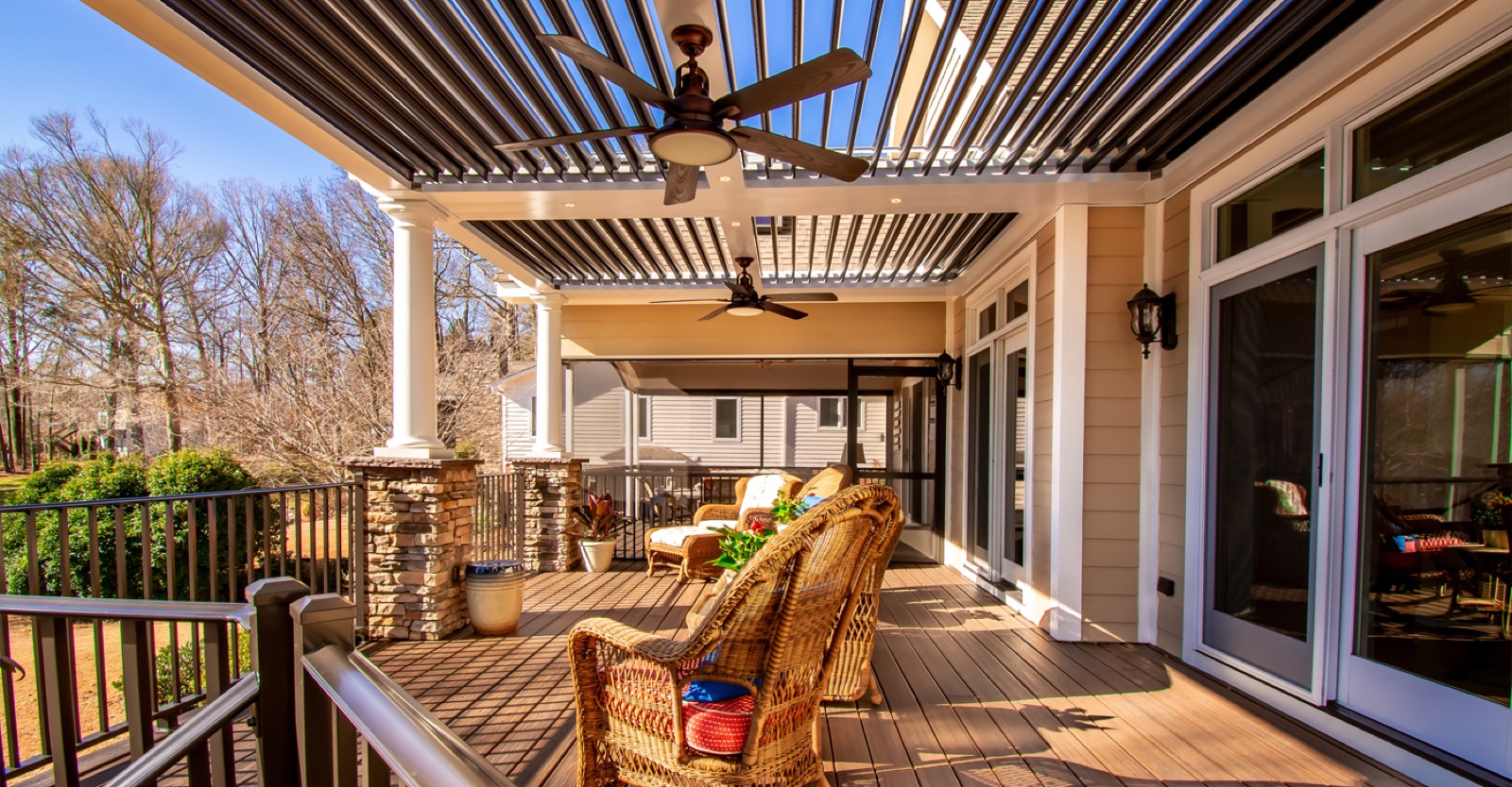 Open louvers cast striped sunlight across a furnished deck
